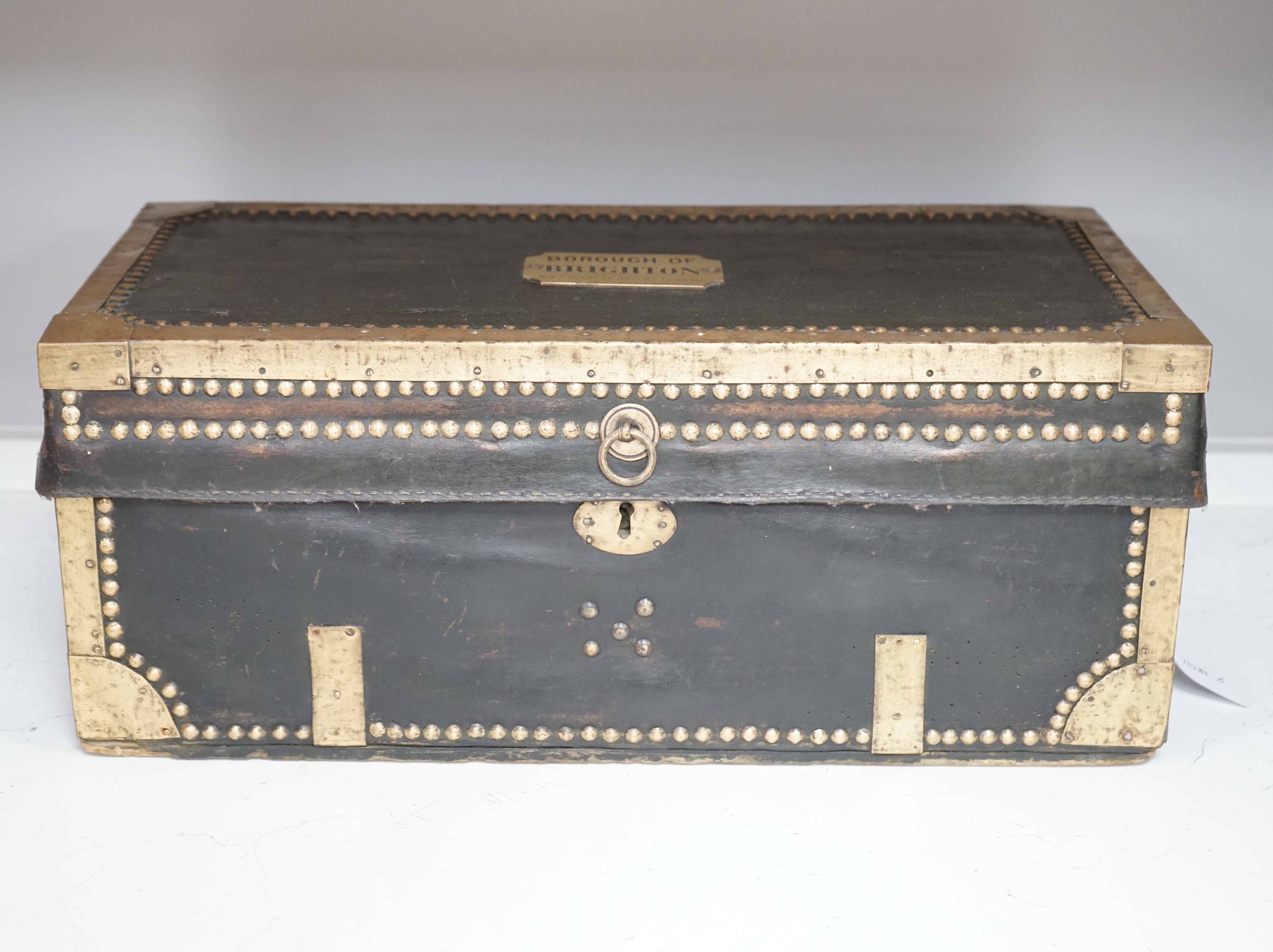 A 19th century leather and brass bound trunk with Avery Ltd applied brass plaque; 'Borough of Brighton', 54cm x 26.5cm x 22cm